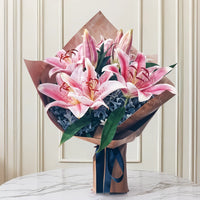 Elegant Pink Lily Bouquet – 4 Fresh Pink Lilies with Lush Green Fillers & Premium Brown Wrapping | Perfect for Birthdays, Anniversaries & Special Occasions